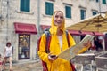 Happy female tourist exploring the city