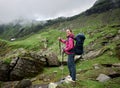 Happy female tourist at hiking in valley of Romanian mountains Royalty Free Stock Photo