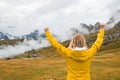 Happy female tourist spreads hands and enjoys the Alps Royalty Free Stock Photo