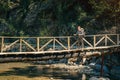 Hiker on the wooden bridge over mountain river in Turkey