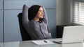 Happy female worker relax at workplace with eyes closed Royalty Free Stock Photo