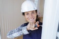 happy female worker screwing window