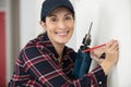 happy female worker with tool level and drill at work Royalty Free Stock Photo