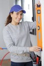 happy female worker woman with level on white Royalty Free Stock Photo