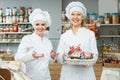 Happy females staff offering sweets