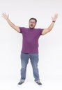 Happy fervent man with glasses raising his arms in victory against a white background, expressing joy and success