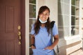 Happy filipina nurse portrait in front of house Royalty Free Stock Photo