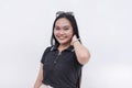 A happy Filipino woman with strong long hair in her early 20s. Wearing a black polo shirt. Isolated on a white background Royalty Free Stock Photo