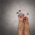 Happy finger couple in love with painted smiley and sing a song