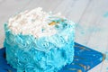 Happy first birthday cake on blue space background