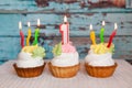 Happy first birthday cake and number one candle on blue background