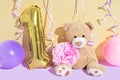 Happy first birthday card with teddy bear, flower and balloons