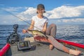 Happy fisher girl with walleye zander fish trophy at the boat Royalty Free Stock Photo