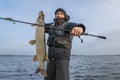 Happy fisherman with big pike fish. Boat fishing Royalty Free Stock Photo