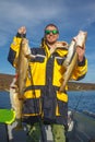 Happy fisherman with cod fish in hands Royalty Free Stock Photo