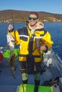 Happy fisherman with cod fish in hands Royalty Free Stock Photo