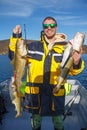 Happy fisherman with cod fish in hands Royalty Free Stock Photo