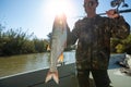 Fisherman holds the Asp fish Royalty Free Stock Photo