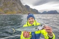 Happy fisherman with mackerel fish in hands Royalty Free Stock Photo