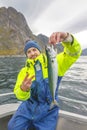 Happy fisherman with mackerel fish in hands Royalty Free Stock Photo