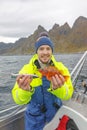 Happy fisherman with rockfish in hands