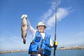 Happy fisherman showing large grouper Royalty Free Stock Photo