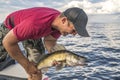 Happy fisherman with walleye zander fish trophy at the boat Royalty Free Stock Photo