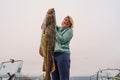 Happy Fisherwoman holding big arctic cod. Norway happy fishing. Woman with cod fish in hands Royalty Free Stock Photo