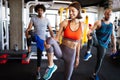 Happy fit friends exercising, working out in gym to stay healthy together Royalty Free Stock Photo