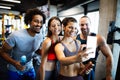 Happy fit friends exercising, working out in gym to stay healthy together Royalty Free Stock Photo