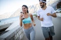 Healthy sporty lifestyle. Happy fit people friends exercising and running outdoor Royalty Free Stock Photo