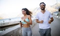 Healthy sporty lifestyle. Happy fit people friends exercising and running outdoor Royalty Free Stock Photo