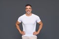 Happy fit sporty mature older man wearing white t-shirt isolated on background. Royalty Free Stock Photo