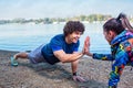 Happy fitness couple giving high five to each other while doing Royalty Free Stock Photo