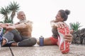 Happy fitness friends doing legs stretching exercises together in outdoor area Royalty Free Stock Photo