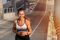 Fitness sporty woman running early in the morning city at sunrise. Healthy lifestyle concept Royalty Free Stock Photo