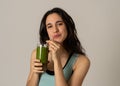 Happy beautiful fit sport woman smiling and drinking healthy fresh vegetable detox smoothie Royalty Free Stock Photo