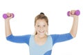 Happy fitness young girl lifting dumbbells smiling cheerful, fresh and energetic