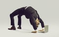 Happy flexible businessman in suit doing yoga while working on his laptop computer