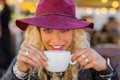Happy and flirty woman drinking hot beverage Royalty Free Stock Photo