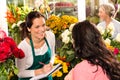 Happy florist writing flower shop talking customer