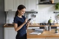 Happy focused gadget user girl browsing Internet on mobile phone
