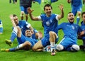 Happy football players celebrate qualifying to FIFA World Cup 2014