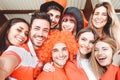 Happy football supporter fans taking a selfie before the world soccer game - Young group of excited friends having fun at stadium