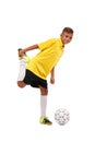 A happy footballer is warming up. A cheerful child in a football uniform isolated on a white background. Full-length Royalty Free Stock Photo