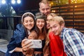 Happy four friends watching internet social media in cell phone. Every one with his own phone Royalty Free Stock Photo