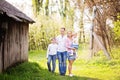 Happy four member family spending spring afternoon together outdoors in orchard Royalty Free Stock Photo