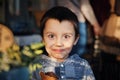 Happy caucasian little boy with face stained a chocolate holding ice cream cone Royalty Free Stock Photo