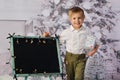 A child with Christmas presents and Christmas tree.