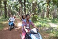 Happy Free Couples Driving Scooter Enjoy Travel In Tropical Forest Cheerful Friends Road Trip Royalty Free Stock Photo